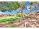 Landscaped backyard with stone benches and golf course view at 1841 Indian Bend Dr, Henderson, NV 89074