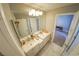 Modern bathroom with double vanity and marble floors at 1849 Indian Bend Dr, Henderson, NV 89074