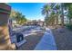 Grand gated entrance to a luxury community with palm trees and landscaping at 1849 Indian Bend Dr, Henderson, NV 89074