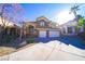 Two-story house with attached two-car garage and landscaping at 1849 Indian Bend Dr, Henderson, NV 89074