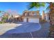 Two-story house with attached two-car garage, landscaping, and curved driveway at 1849 Indian Bend Dr, Henderson, NV 89074