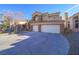 Two-story house with a three-car garage and attractive facade at 1849 Indian Bend Dr, Henderson, NV 89074