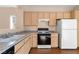 Kitchen with light wood cabinets, granite counters and stainless steel appliances at 2185 Indigo Creek Ave, Henderson, NV 89012