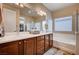 Elegant bathroom with double sinks, soaking tub, and large mirror at 2452 Blair Castle St, Henderson, NV 89044