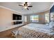 Main bedroom with large TV and ceiling fan at 2452 Blair Castle St, Henderson, NV 89044