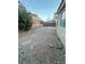 Spacious backyard with gravel, brick walls, and a partially tiered layout, offering potential for customization at 2536 Grand Basin Dr, Las Vegas, NV 89156