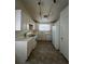 Functional kitchen featuring white cabinetry, neutral countertops and flooring, and ample natural light at 2536 Grand Basin Dr, Las Vegas, NV 89156