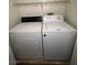 Functional laundry room equipped with a washer, dryer, and wire shelving for convenient storage at 2536 Grand Basin Dr, Las Vegas, NV 89156