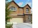 Two-story house with beige exterior, attached garage, and landscaping at 3641 Via Terracina, Henderson, NV 89052