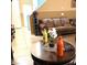 Living room with leather couches, coffee table, and decorative plants at 3641 Via Terracina, Henderson, NV 89052