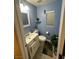 Compact bathroom with a toilet, sink, window and neutral walls, offering a clean and functional space at 6216 Pangea Ave, Las Vegas, NV 89139