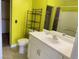 Full bathroom with a white vanity and an adjacent walk-in closet for convenient storage at 6216 Pangea Ave, Las Vegas, NV 89139