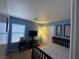 Bedroom featuring blue walls, carpet, and a bed; illuminated by a floor lamp at 6216 Pangea Ave, Las Vegas, NV 89139