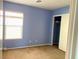 Bedroom featuring blue walls, carpeting, and sliding closet doors at 6216 Pangea Ave, Las Vegas, NV 89139