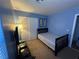 Bedroom featuring blue walls, carpet, and a bed, illuminated by a floor lamp at 6216 Pangea Ave, Las Vegas, NV 89139