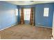 Spacious bedroom with neutral carpet, large windows, and soft lighting, creating a serene atmosphere at 6216 Pangea Ave, Las Vegas, NV 89139