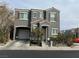Two-story home featuring a two-car garage, neutral stucco exterior, and well-maintained landscaping at 6216 Pangea Ave, Las Vegas, NV 89139