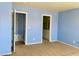 Hallway with blue walls, carpet, and doors leading to other rooms at 6216 Pangea Ave, Las Vegas, NV 89139