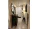 Inviting hallway with tiled flooring, decorative mirror, and view to front door at 6216 Pangea Ave, Las Vegas, NV 89139