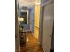 Hallway with wood floor, blue walls, and doors leading to other rooms at 6216 Pangea Ave, Las Vegas, NV 89139
