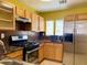 Well-lit kitchen featuring stainless steel appliances, wooden cabinets, and a functional layout at 6216 Pangea Ave, Las Vegas, NV 89139