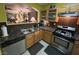Functional kitchen featuring stainless steel appliances, wood cabinets, and dark countertops at 6216 Pangea Ave, Las Vegas, NV 89139