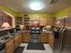Well-lit kitchen featuring stainless steel appliances, wooden cabinets, and a functional layout at 6216 Pangea Ave, Las Vegas, NV 89139
