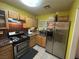 Kitchen with stainless steel appliances, tile backsplash, and wood cabinetry at 6216 Pangea Ave, Las Vegas, NV 89139
