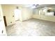 Spacious living room featuring neutral walls, tile flooring, and large mirrored wall at 6216 Pangea Ave, Las Vegas, NV 89139
