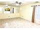 Living area with neutral walls, tile floors, large window with curtain, and wall mirror at 6216 Pangea Ave, Las Vegas, NV 89139