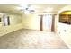 Bright, open living space with tile floors, neutral walls, a ceiling fan, and a mirrored wall at 6216 Pangea Ave, Las Vegas, NV 89139