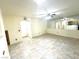 Living area features tile flooring, mirrored wall, neutral color paint, and ceiling fan at 6216 Pangea Ave, Las Vegas, NV 89139