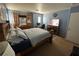 Cozy main bedroom featuring a wooden bed frame, carpeted floors, and a comfortable layout at 6216 Pangea Ave, Las Vegas, NV 89139