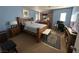 Cozy main bedroom featuring a wooden bed frame, carpeted floors, and a comfortable layout at 6216 Pangea Ave, Las Vegas, NV 89139