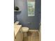 A compact powder room with a pedestal sink and a view-framing window for ample natural light at 6216 Pangea Ave, Las Vegas, NV 89139