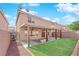 Landscaped backyard with covered patio and built-in grill at 6360 Stag Hollow Ct, Las Vegas, NV 89139