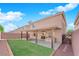 Landscaped backyard with covered patio and built-in grill at 6360 Stag Hollow Ct, Las Vegas, NV 89139