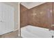 Bathroom with large bathtub, tiled walls, and updated vanity at 6360 Stag Hollow Ct, Las Vegas, NV 89139