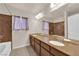 Double vanity bathroom with granite countertops and a shower/tub combo at 6360 Stag Hollow Ct, Las Vegas, NV 89139