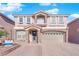 Two-story house with stone accents and a three-car garage at 6360 Stag Hollow Ct, Las Vegas, NV 89139
