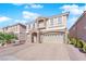 Two-story house with stone accents and a three-car garage at 6360 Stag Hollow Ct, Las Vegas, NV 89139