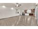 Open living room and kitchen with hardwood floors and modern kitchen island at 6360 Stag Hollow Ct, Las Vegas, NV 89139