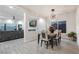 Elegant dining room with chandelier and seating for six at 6407 Carmel Creek Ave, Las Vegas, NV 89139