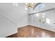 Bright entryway with hardwood floors, chandelier, and staircase at 9809 La Vid Ct, Las Vegas, NV 89117