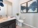 Modern bathroom boasts dark vanity, patterned wallpaper, and a toilet at 10325 Jade Point Dr, Las Vegas, NV 89135