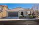 Single-story home with a two-car garage and landscaping at 149 Attingham Park Ave, Henderson, NV 89002