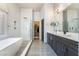Bright bathroom with modern shower, soaking tub, double vanity, and walk-in closet at 2144 Paganini Ave, Henderson, NV 89052