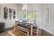 Dining area featuring a wooden table, bench seating, modern lighting, and a wine rack for storage at 2144 Paganini Ave, Henderson, NV 89052