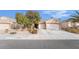 Charming single-story home with a well-manicured lawn and a three-car garage in a residential neighborhood at 2144 Paganini Ave, Henderson, NV 89052