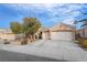 Inviting home featuring a neutral exterior, a well-kept front yard, and a two-car garage with ample parking space at 2144 Paganini Ave, Henderson, NV 89052